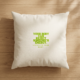 A square cream-colored cushion in natural woven fabric lies on warm light oak floorboards, with soft shadows of sunlight across the surface. In the center, bold lime green lettering reads “Your body can reject someone’s energy,” with a smaller line below: “Listen to your body.”